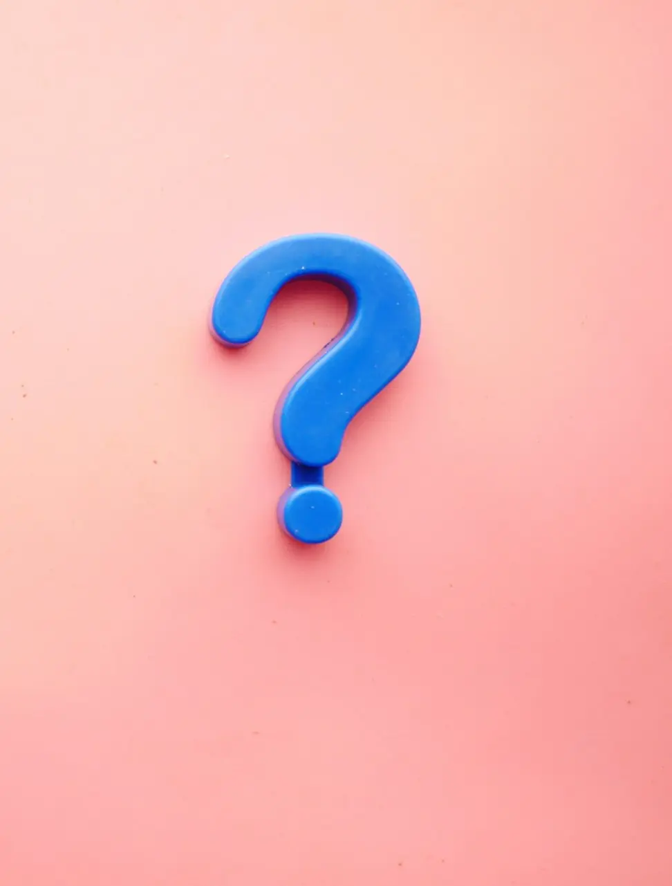 a blue question mark on a pink background